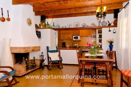 Dining area with fireplace and kitchen